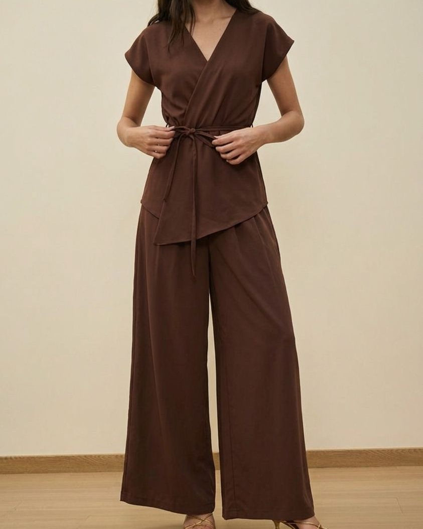 Woman wearing a brown outfit with a plain background